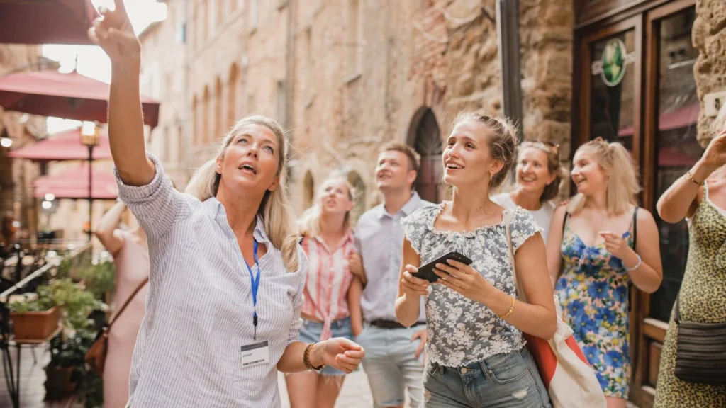 Tour guide leading a group through a cobblestone European street
