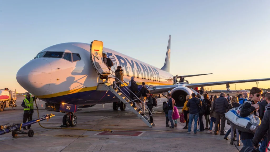 Passengers boarding a Ryanair flight on a sunny evening at the airport