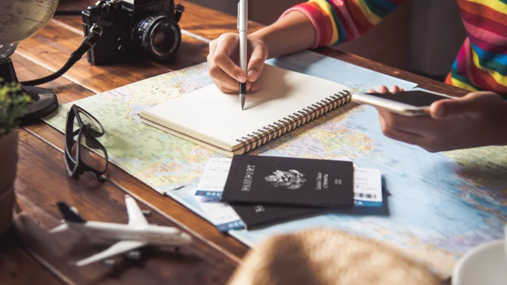 A traveler planning a trip with maps, notebooks, and a passport