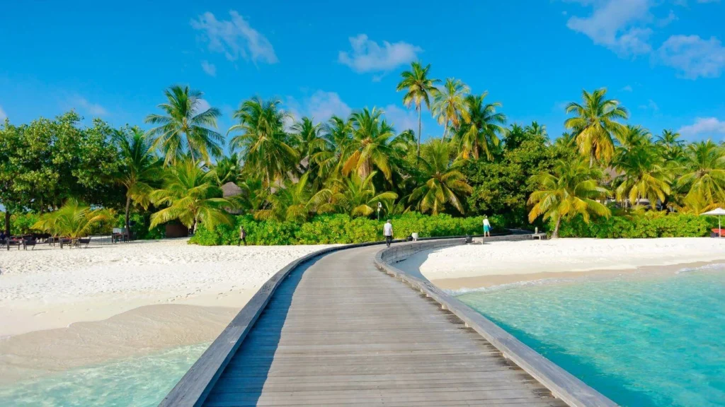 Luxury overwater bungalow in Fiji with turquoise water and lush greenery